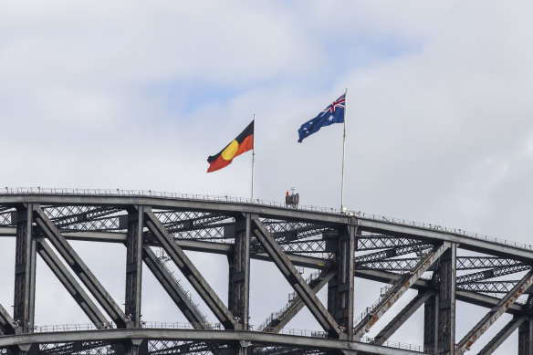 The Australian and Aboriginal flags flying high on the Sydney Harbour Bridge on Australia Day last year.