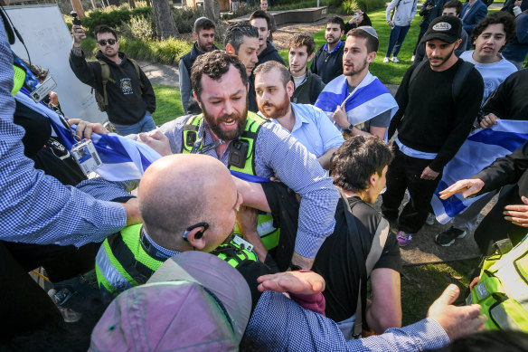 Counter-demonstrators clash with university security at Monash on Wednesday.