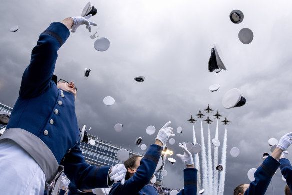Graduates toss their hats at the conclusion of the 2023 United States Air Force Academy Graduation Ceremony at Falcon Stadium in Colorado Springs, Colorado.