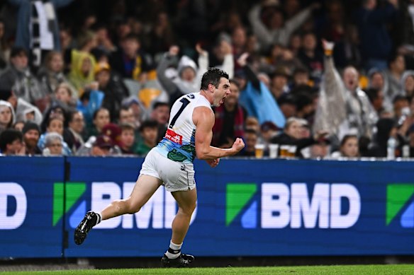 Shaun Mannagh of the Cats celebrates kicking a goal.