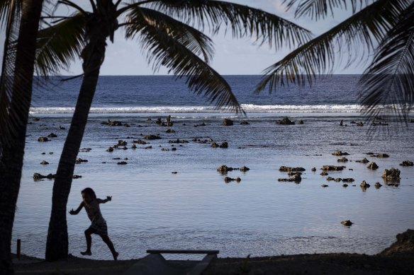 A child plays near the beach in Nauru.