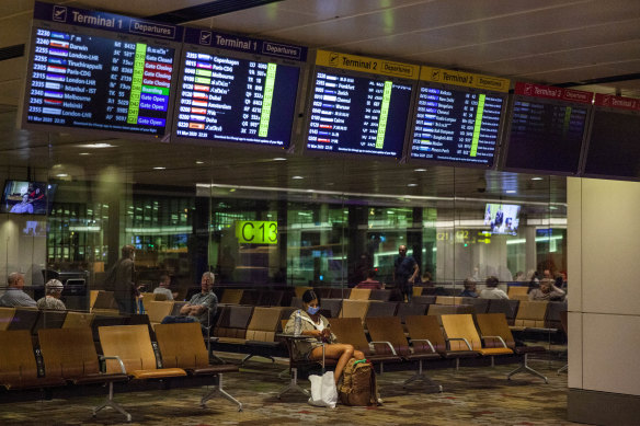 Travellers waits at Changi Airport in Singapore.