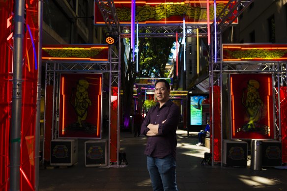 Haymarket HQ founder Brad Chan with the glowing light installations lighting up Chinatown.