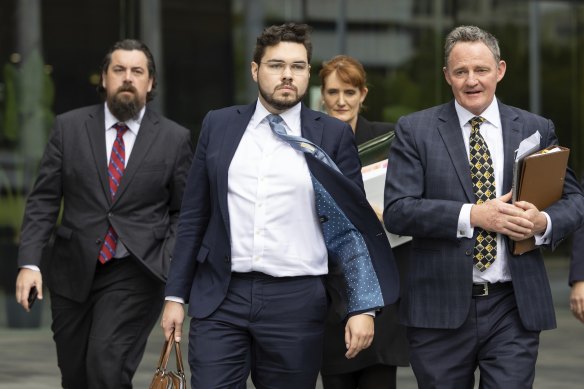 Bruce Lehrmann (centre) leaving court in Canberra on Tuesday.