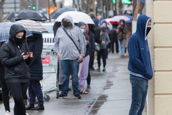 People line up to get a COVID test in Collingwood on Tuesday.