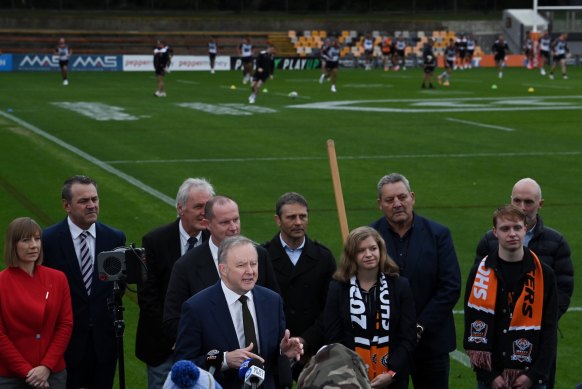 Australian Prime Minister Anthony Albanese during a press conference as the West Tigers train in the background at Leichhardt Oval. 