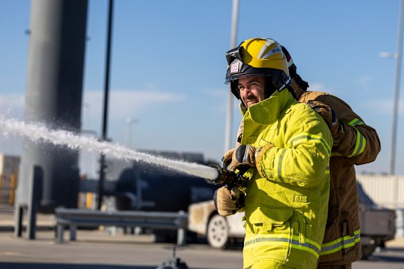 Journalist Benjamin Preiss being put through his paces in firefighting training.