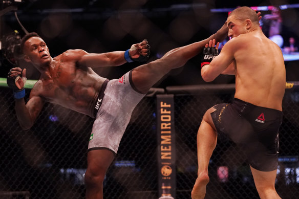 Israel Adesanya (left) was too strong for his Australian rival, Robert Whittaker. 
