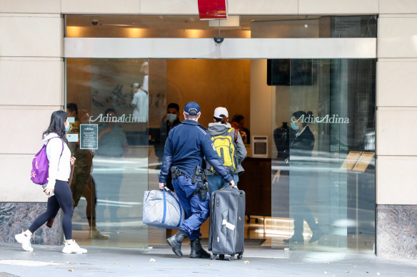 Travellers  returning from overseas escorted to hotel quarantine in Sydney.