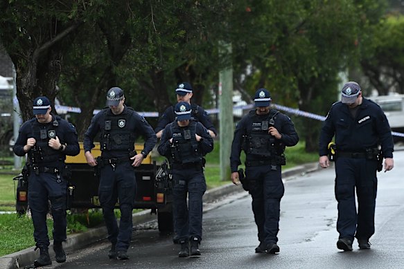 NSW police conducting a line search in Fairfield East, where the burnt car was located. 