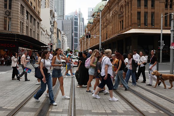 Pedestrians at the corner of George and Market streets, Sydney.