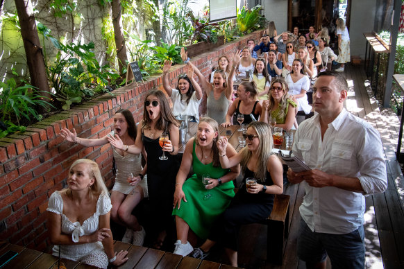Patrons at the Prince Alfred Hotel in Richmond, including Glen Perry and Molly Tobin, at front, cheer on the horses on Tuesday.