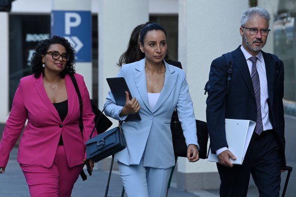 Antoinette Lattouf (centre) arrives at the Fair Work Commission for her hearing against the ABC.