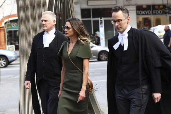 Bianca Rinehart flanked by her lawyers.