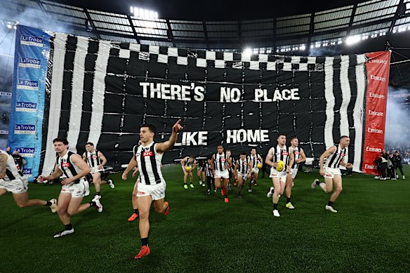 Nick Daicos of the Magpies leads out the team.