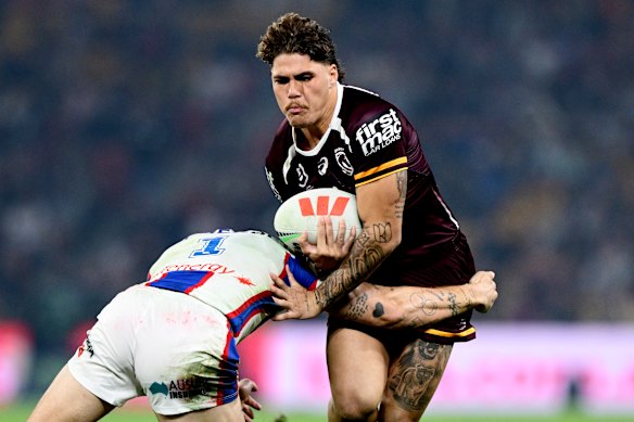 Reece Walsh of the Broncos takes on the defence of Kalyn Ponga of the Knights at Suncorp Stadium on Saturday