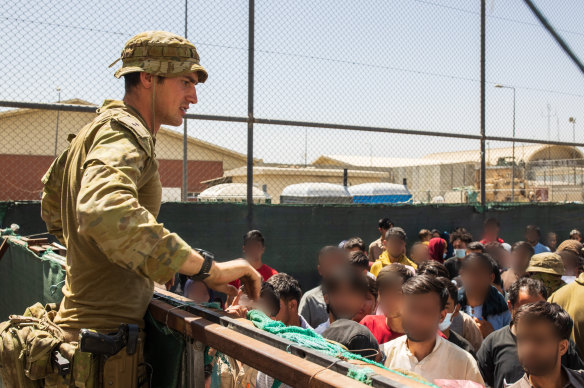 Defence personnel helping Afghan evacuees leave Kabul in August.