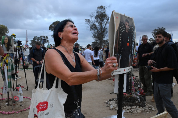 On the first anniversary of the October 7 Hamas attack, Rachel Moshe mourns her son Oz Ezra  at his shrine at the site of the Nova music festival.