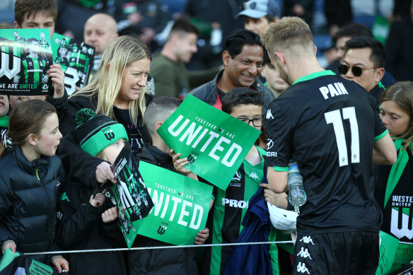 At home: Connor Pain signs autographs for Western United fans. 