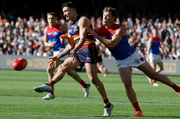 Izak Rankine of the Crows is tackled by Jake Melksham.