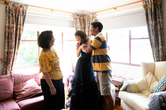 Daphne Fong with her parents, Selin and Martin Fong, as she prepares to leave for her school formal after months of uncertainty.