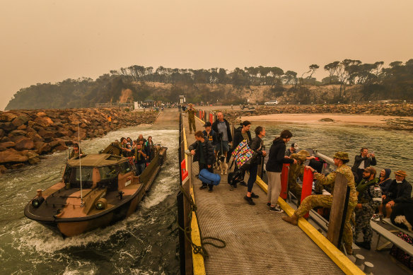  Evacuees prepare to leave Mallacoota on Friday morning.