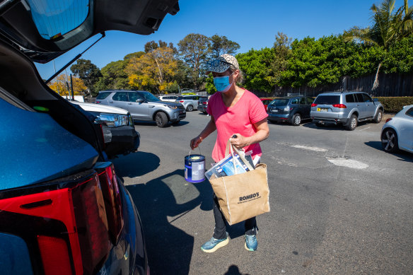Summer Hill resident Claire Prideaux packs items into her car after visiting a Bunnings store in Ashfield.