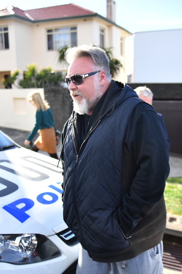Kyle Sandilands arrives at John Ibrahim's house during a police operation on Tuesday.