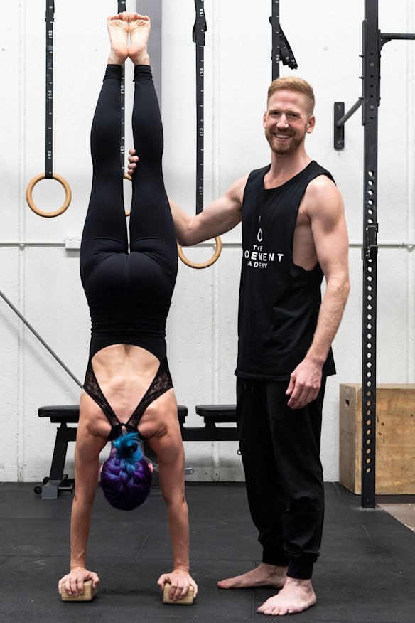 Professional acrobat Brendan Irving supports Jade Twist during a handstand.