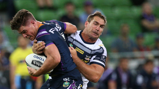 Storm halfback Brodie Croft  runs into North Queensland's Scott Bolton on Thursday night at AAMI Park.
