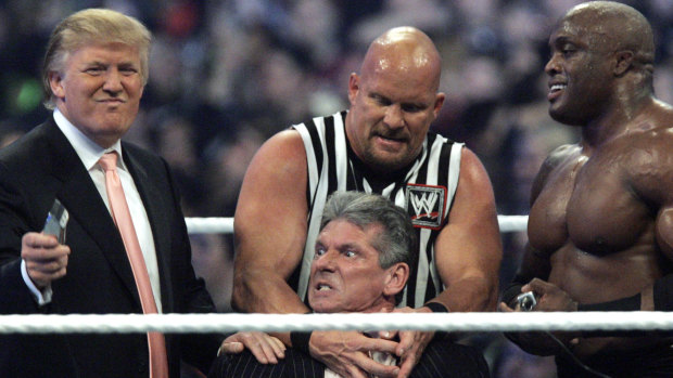 McMahon, centre, being held by "Stone Cold" Steve Austin and Donald Trump at Wrestlemania 23.