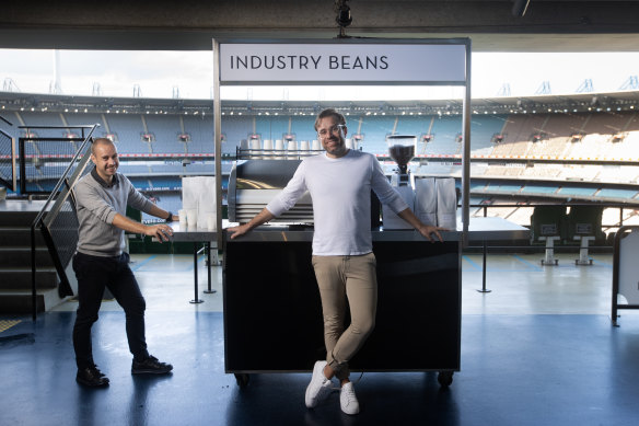 Industry Beans founders Steve Simmons (left) and brother Trevor Simmons with one of their coffee carts at the MCG.