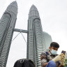 A man looks at his mobile phone in front of Twin Towers in Kuala Lumpur, Malaysia. Huawei is tipped as the frontrunner to build the country’s 5G network.