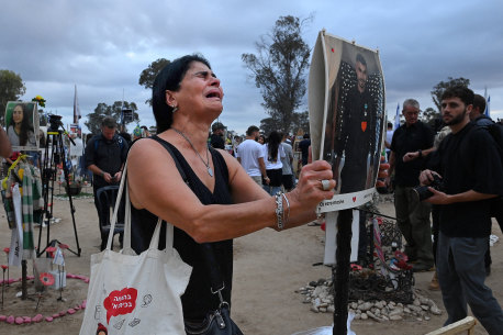 On the first anniversary of the October 7 Hamas attack, Rachel Moshe mourns her son Oz Ezra at his shrine at the site of the Nova music festival.