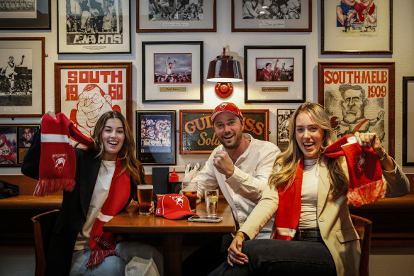 Swans fans Sophie Morris, Zac Chapman and Chelsea Schultz enjoy a drink at the Rising Sun.