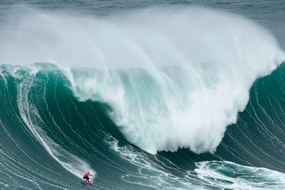 No chance: Maya Gabeira from Brazil, rides a wave during the Nazare Big Wave Challenge surfing tournament at Praia do Norte in Nazare, Portugal. Walsh headed further afield to find his wave to surf.