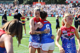 Tayla Harris and Daisy Pearce of the Demons react during the 2022 AFLW Grand Final match between the Adelaide Crows and the Melbourne Demons at Adelaide Oval on April 09, 2022.