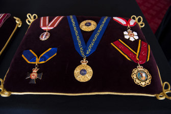 The insignia for Philip’s Knight of the Order of Australia rests on the centre of the cushion.