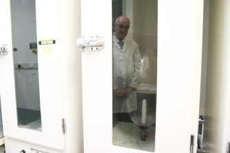 Professor Skerritt observes condom testing. The TGA has tested condoms since the HIV/AIDS epidemic.