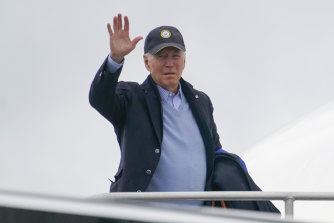 US President Joe Biden waves as he boards Air Force One at Nantucket Memorial Airport, in Nantucket, Massachusetts.