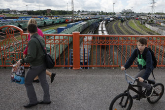 People on a bridge over the railroad tracks of the freight station in Kaliningrad, Russia, on Tuesday, June 21, 2022.