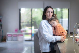 Carla Bottari, with daughter Sophie, is keeping her two children home at the request of her childcare centre, which has been hard hit by COVID.