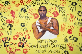 A banner of David Dungay Junior placed outside court during the inquest into his death.