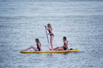 Paddle-boarders seek a reprieve from the Melbourne heat.