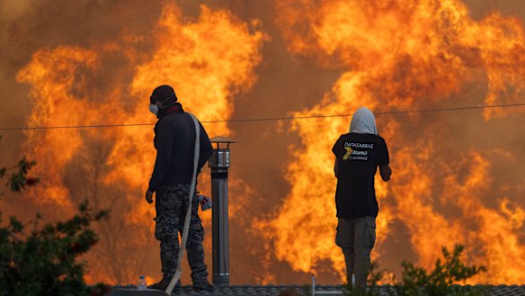 Fire approaches the Greek village of Gennadi. This year’s fires across the northern hemisphere will push up reinsurer premiums that will then hit domestic insurance prices.