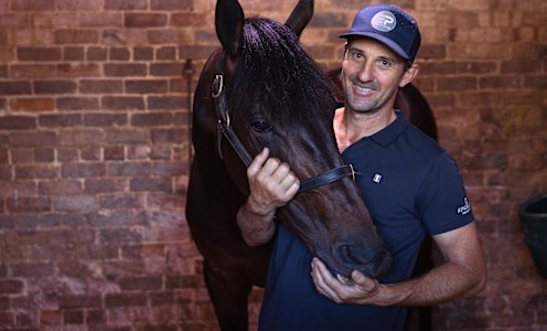 Horse physio Tom Simpson with Melbourne Cup contender Athabascan at Randwick racecourse.