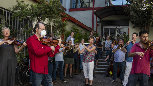 Members of the orchestra of Opera Australia performing with their instruments outside the offices of Opera Australia in March to call on the company to reconsider its decision to stand down musicians without pay. 