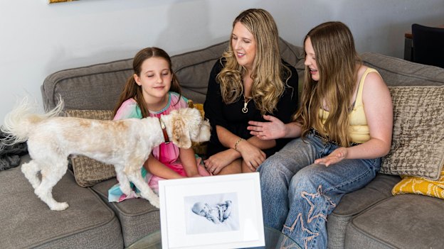 Catherine Hughes in her Perth home with daughters Lucy and Olivia, as well as dog Augustus. She founded the Immunisation Foundation of Australia after her 4-week old baby Riley died from whooping cough, a vaccine-preventable disease.