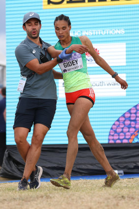 Letesenbet Gidey of Team Ethiopia receives attention from medical staff.