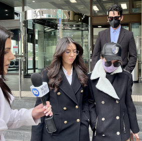 Yuteng Zhang, 32, and Jess Fang Ching Ting, 37 (both masked), leave court on Friday. 